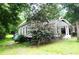 The exterior view showcasing the side of the home and ample greenery at 510 5Th St, Spencer, NC 28159
