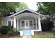 Charming home featuring a covered front porch with white pillars and blue painted steps at 510 5Th St, Spencer, NC 28159