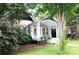 Cozy home featuring a covered front porch and landscaped yard with mature trees at 510 5Th St, Spencer, NC 28159