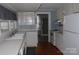 Functional kitchen with essential appliances and ample counter space adjacent to an adjacent room at 510 5Th St, Spencer, NC 28159