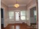 Spacious living room featuring hardwood floors, large windows and a vintage chandelier at 510 5Th St, Spencer, NC 28159