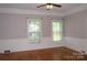 Bright living room featuring hardwood floors, baseboard trim, and large windows at 510 5Th St, Spencer, NC 28159