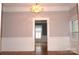 Bright living room featuring hardwood floors, baseboard trim, and views into other rooms at 510 5Th St, Spencer, NC 28159