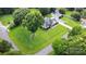 Overhead view of property with house, detached garage, manicured lawn and mature trees in a rural setting at 5701 Cedar Hill Dr, Monroe, NC 28110