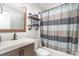 Bathroom featuring a vanity and tub with a striped shower curtain and wood floors at 5701 Cedar Hill Dr, Monroe, NC 28110