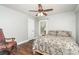 Bedroom featuring hardwood floors, a ceiling fan, and a comfortable bed at 5701 Cedar Hill Dr, Monroe, NC 28110