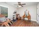 A bonus room with a ceiling fan, exercise bike, unique antique vanity, and hardwood floors at 5701 Cedar Hill Dr, Monroe, NC 28110