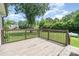 Outdoor deck with wood railing perfect for entertaining with a spacious yard view at 5701 Cedar Hill Dr, Monroe, NC 28110