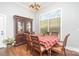 Formal dining room with hardwood floors, a large window, and decorative furniture at 5701 Cedar Hill Dr, Monroe, NC 28110