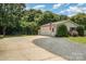 Spacious driveway leading to a detached garage, complete with an American flag and well-kept landscaping at 5701 Cedar Hill Dr, Monroe, NC 28110