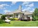 Rear exterior of a home featuring a small deck and well-maintained landscaping at 5701 Cedar Hill Dr, Monroe, NC 28110