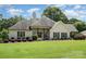 Charming single-story home with lush landscaping and a welcoming front porch at 5701 Cedar Hill Dr, Monroe, NC 28110
