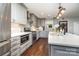 A modern kitchen with stainless steel appliances, gray cabinets and a large center island with white countertop at 5701 Cedar Hill Dr, Monroe, NC 28110