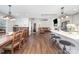 Bright, open-concept living space features hardwood floors, eat-in kitchen with island, and dining area at 5701 Cedar Hill Dr, Monroe, NC 28110