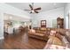 Comfortable living room with hardwood floors, large sofa, and view into the kitchen and dining area at 5701 Cedar Hill Dr, Monroe, NC 28110