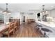 Bright, open-concept living space features hardwood floors, eat-in kitchen with island, and dining area at 5701 Cedar Hill Dr, Monroe, NC 28110