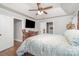 Comfortable main bedroom with ceiling fan, television, and wood floors at 5701 Cedar Hill Dr, Monroe, NC 28110