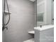 Modern shower with gray tiled walls, seat, and glass partition at 5701 Cedar Hill Dr, Monroe, NC 28110