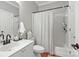 Clean bathroom featuring a white vanity, toilet, and shower-tub with a curtain at 5730 Closeburn Rd # N, Charlotte, NC 28210