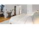 Bright bedroom with a walk-in closet, workspace desk, and white bedding at 5730 Closeburn Rd # N, Charlotte, NC 28210