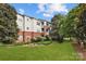 Apartment building featuring manicured lawn and lush landscaping at 5730 Closeburn Rd # N, Charlotte, NC 28210