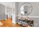 Hallway with hardwood floors, shelving unit, and decorative mirror at 5730 Closeburn Rd # N, Charlotte, NC 28210