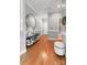 Hallway with wood floors, decorative mirror, and access to other rooms at 5730 Closeburn Rd # N, Charlotte, NC 28210