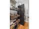 Laundry area with stacked washer and dryer, shelving, and hardwood floors at 5730 Closeburn Rd # N, Charlotte, NC 28210