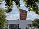 Retro Park Road Shopping Center sign against a blue sky, framed by trees at 5730 Closeburn Rd # N, Charlotte, NC 28210