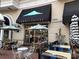 Summit Coffee shop entrance with outdoor seating and umbrellas for a comfortable experience at 5730 Closeburn Rd # N, Charlotte, NC 28210