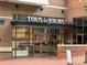Tous Les Jours Cafe storefront with a brick facade and clear display of baked goods inside at 5730 Closeburn Rd # N, Charlotte, NC 28210