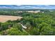 Stunning aerial view of an estate nestled among trees, showing its meticulous landscaping and spacious driveway at 6327 Fox Tail Ln, Davidson, NC 28036