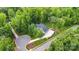 Aerial view of a beautiful estate featuring lush landscaping, a circular driveway, and a large garage at 6327 Fox Tail Ln, Davidson, NC 28036
