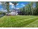Expansive backyard with lush lawn and mature trees surrounding the property, offering privacy and serenity at 6327 Fox Tail Ln, Davidson, NC 28036
