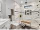 Bright bathroom with a marble shower, a bench, and gray tile floors at 6327 Fox Tail Ln, Davidson, NC 28036