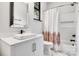 Bright bathroom featuring vanity with square sink, white marble floors and shower at 6327 Fox Tail Ln, Davidson, NC 28036