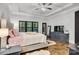 Well lit primary bedroom featuring hardwood floors, a tray ceiling, and a TV at 6327 Fox Tail Ln, Davidson, NC 28036