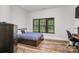 Comfortable bedroom bathed in natural light, complemented by wood flooring and a calming color scheme at 6327 Fox Tail Ln, Davidson, NC 28036