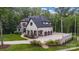 Elegant home featuring a three-car garage and expansive paved parking area at 6327 Fox Tail Ln, Davidson, NC 28036