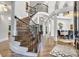 Grand foyer showcasing a beautiful curved staircase and hardwood flooring at 6327 Fox Tail Ln, Davidson, NC 28036