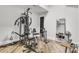 Basement gym fully equipped with workout machines and a floor-to-ceiling mirror, promoting a healthy lifestyle at 6327 Fox Tail Ln, Davidson, NC 28036