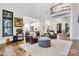 Open-concept living room with hardwood floors, leather furniture and bright white trim at 6327 Fox Tail Ln, Davidson, NC 28036