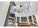 Vaulted living room with lots of windows, a fireplace and leather seating at 6327 Fox Tail Ln, Davidson, NC 28036