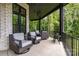 Enjoy the outdoors from this covered patio featuring wooded views and comfortable seating at 6327 Fox Tail Ln, Davidson, NC 28036