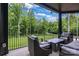 Relax on the covered patio with wooded views and comfortable seating at 6327 Fox Tail Ln, Davidson, NC 28036