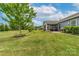 Expansive backyard featuring a lush lawn, mature trees, and a screened-in porch perfect for outdoor relaxation at 732 Wood Lily Dr, Belmont, NC 28012