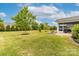 Lush backyard featuring mature trees, a charming patio, and a serene screened-in porch for relaxation and enjoyment at 732 Wood Lily Dr, Belmont, NC 28012