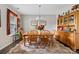 Traditional dining room with a wooden table, chairs, and a vintage hutch for elegant storage at 732 Wood Lily Dr, Belmont, NC 28012