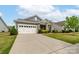 Well-maintained single-story home featuring a two-car garage, stone accents, and a lush green lawn at 732 Wood Lily Dr, Belmont, NC 28012