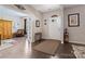 Bright foyer with hardwood floors, decorative accents, and an open doorway to the living area at 732 Wood Lily Dr, Belmont, NC 28012